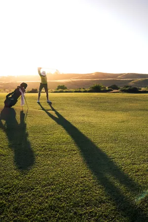 2 Person Walking On Green Grass Field During Daytime Wallpaper