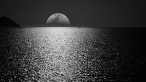2560 X 1440 Large Moon At Sea Wallpaper