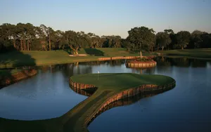 4k Golf Course Surrounded With Water Wallpaper