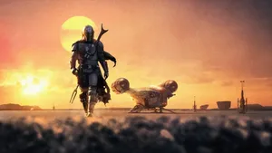 4k The Mandalorian Boba Fett Approaching Against Sunset Wallpaper