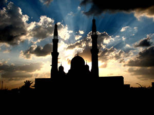 A Beautiful Nighttime Silhouette Of An Islamic Mosque. Wallpaper