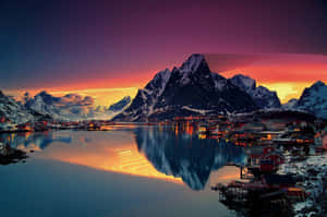 A Beautiful Sunset Over A Lake And Mountains Wallpaper