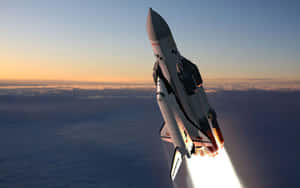 A Beautiful View Of A Space Shuttle Soaring In The Clouds Wallpaper