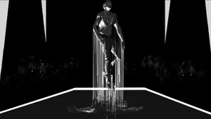 A Black And White Image Of A Woman Standing On A Platform Wallpaper