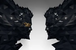 A Black And White Image Of Two Faces With Gold Heads Wallpaper