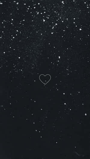 A Black Background With A Heart In The Sky Wallpaper
