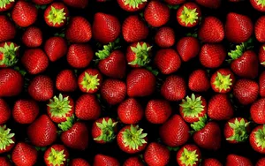 A Black Background With Many Strawberries Wallpaper