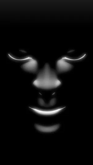A Black Face With Glowing Eyes Wallpaper