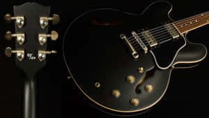 A Black Guitar With A Black Headstock Wallpaper