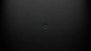 A Black Phone With A Blue Button On It Wallpaper