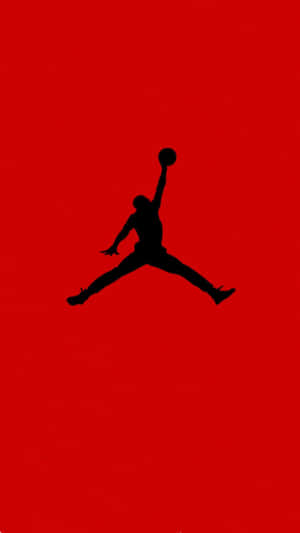 A Black Silhouette Of A Jordan Jumper On A Red Background Wallpaper