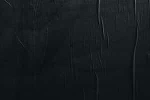 A Black Wall With A Black Paint Wallpaper