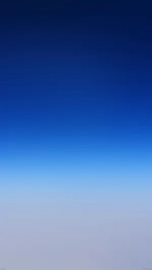 A Blue Sky With Clouds And A Plane Flying Over It Wallpaper