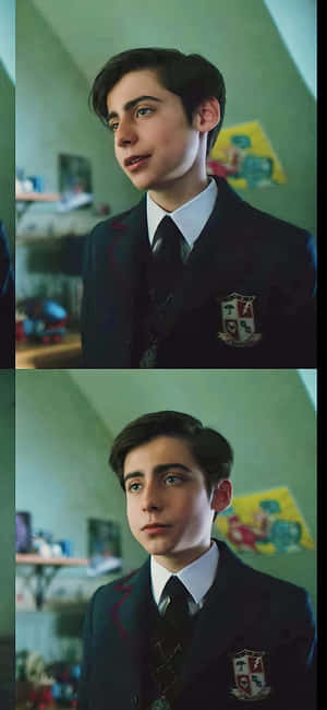 A Boy In A School Uniform Is Looking At The Camera Wallpaper