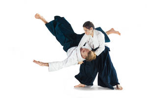 A Breakthrough Moment: Female Aikidokas Executing Koshi-nage Technique Wallpaper