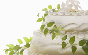 A Breathtaking Display Of Sophisticated Green Vine White Wedding Cake Wallpaper