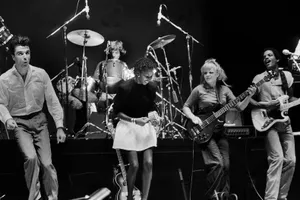 A Captivating Shot Of The Team Of Talking Heads In Their Element, On Stage. Wallpaper