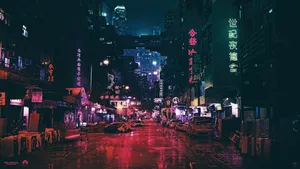A City Street At Night With Neon Lights Wallpaper