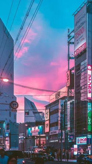 A City Street With A Pink Sky Wallpaper