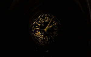 A Clock In A Dark Building Wallpaper