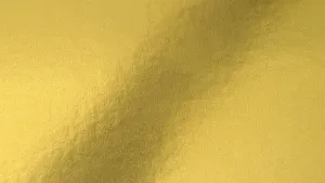 A Close Up Of A Metallic Gold Surface Wallpaper