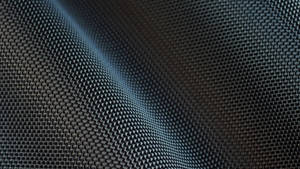 A Close-up Of Wavy Carbon Fiber Wallpaper