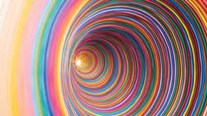 A Colorful Tunnel With A Light Shining Through It Wallpaper