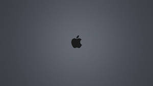 A Dark-gray Background Illuminated By The Iconic Black Apple Logo Wallpaper