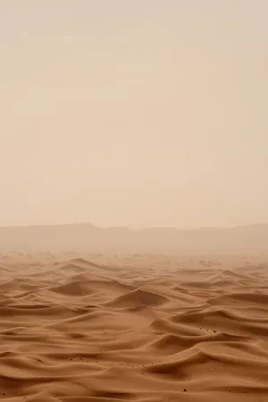 A Desert Landscape With Sand And Mountains Wallpaper