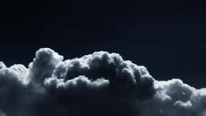 A Dramatic View Of Low-hanging Clouds Against A Black And White Sky. Wallpaper