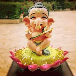 A Fascinating Image Depicts A Baby Statue Of Bal Ganesh Smiling While Sitting On A Lotus Flower Stamen. Wallpaper