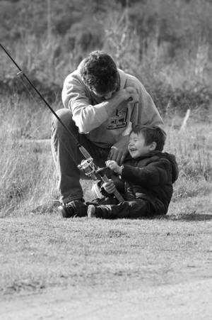 A Father And Son Bonding Over A Shared Fishing Experience. Wallpaper