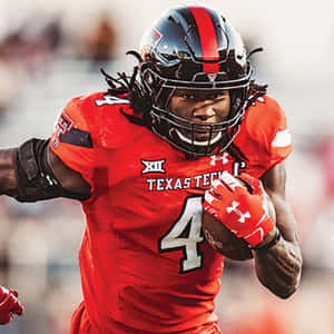 A Football Player Running With A Ball Wallpaper