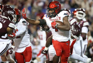 A Football Player Running With The Ball Wallpaper