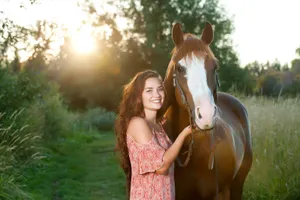A Girl Poses With A Horse In A Field Wallpaper