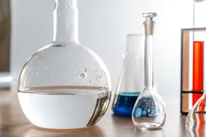 A Group Of Laboratory Flasks And A Glass Of Water Wallpaper