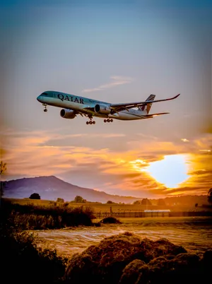 A Jet Plane Flying Over A Field Wallpaper