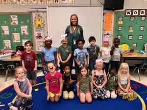 A Joyful Kindergarten Teacher Interacting With Costumed Students In Class. Wallpaper