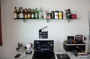 A Laptop Computer On A Shelf Wallpaper