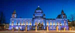 A Large Building Lit Up At Night Wallpaper