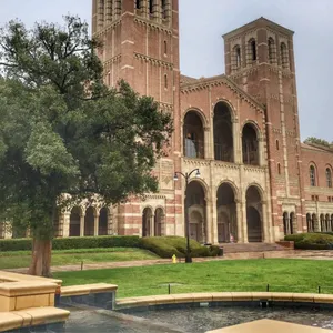 A Large Building With A Fountain In Front Of It Wallpaper