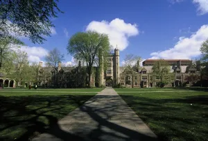 A Large Building With Trees And Grass In The Background Wallpaper
