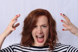 A Lone Figure Expressing Frustration In A Desolate Urban Landscape. Wallpaper