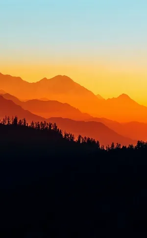 A Magical Sunset Behind Mountains Wallpaper