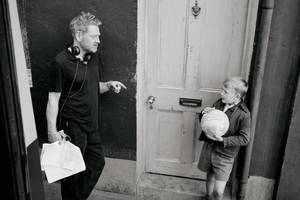 A Man And A Boy Standing Outside A Door Wallpaper