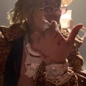 A Man In A Leopard Jacket Is Holding A Gun Wallpaper