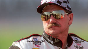 A Man In A Nascar Uniform With Sunglasses Wallpaper