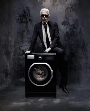 A Man In A Suit Sitting On A Washing Machine Wallpaper