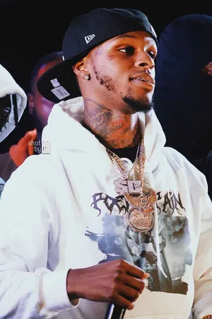 A Man In A White Hoodie Is Holding A Microphone Wallpaper