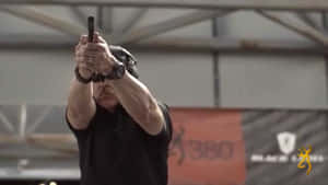 A Man Is Holding A Gun In His Hand Wallpaper